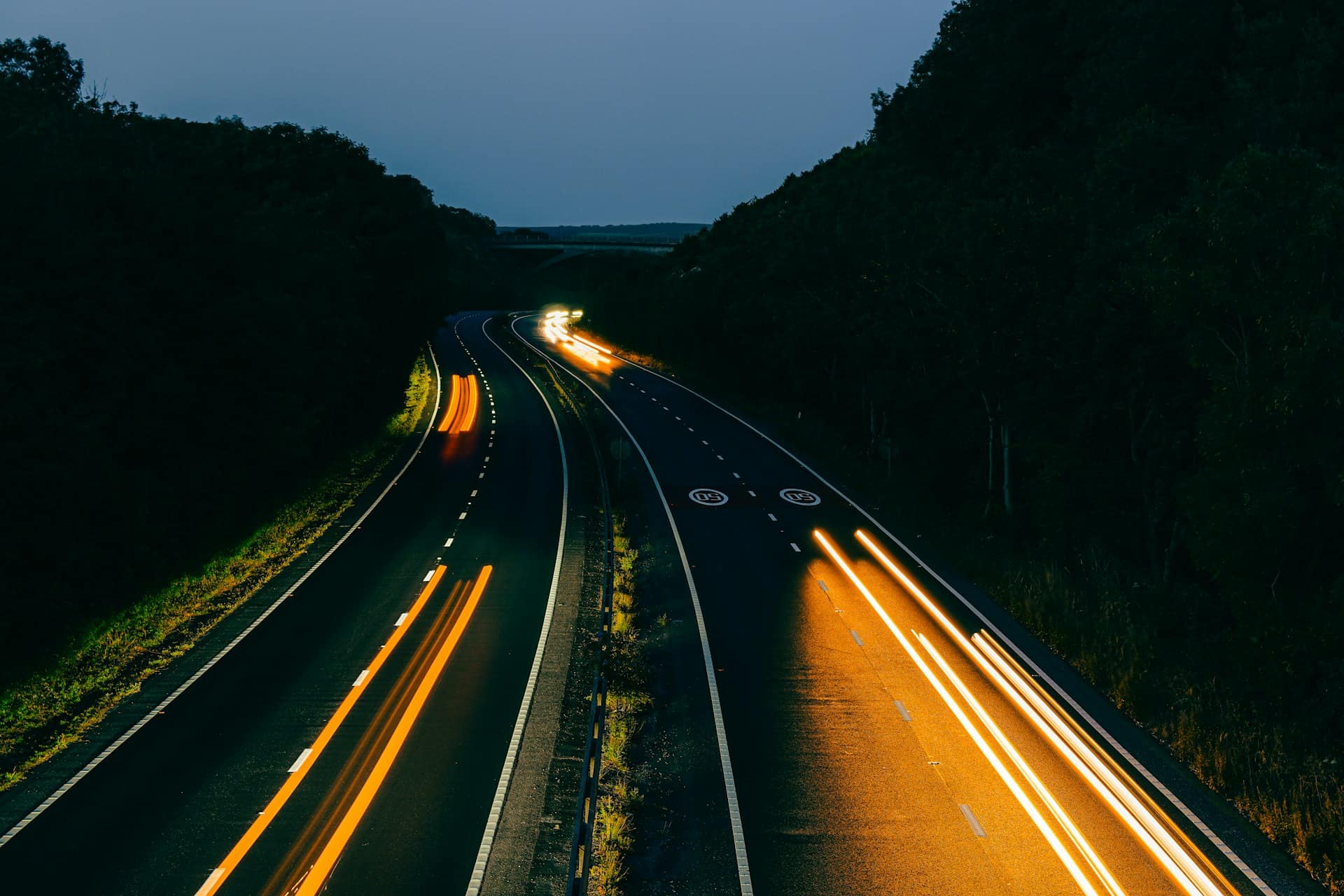 Long-exposure light trails on a highway at night